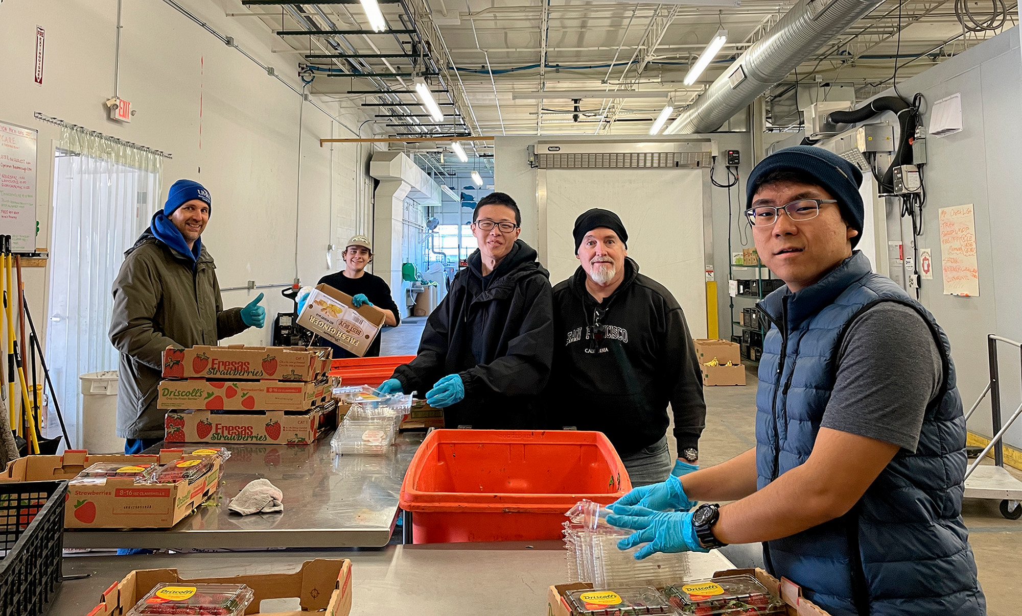 ALI students and faculty sorting produce