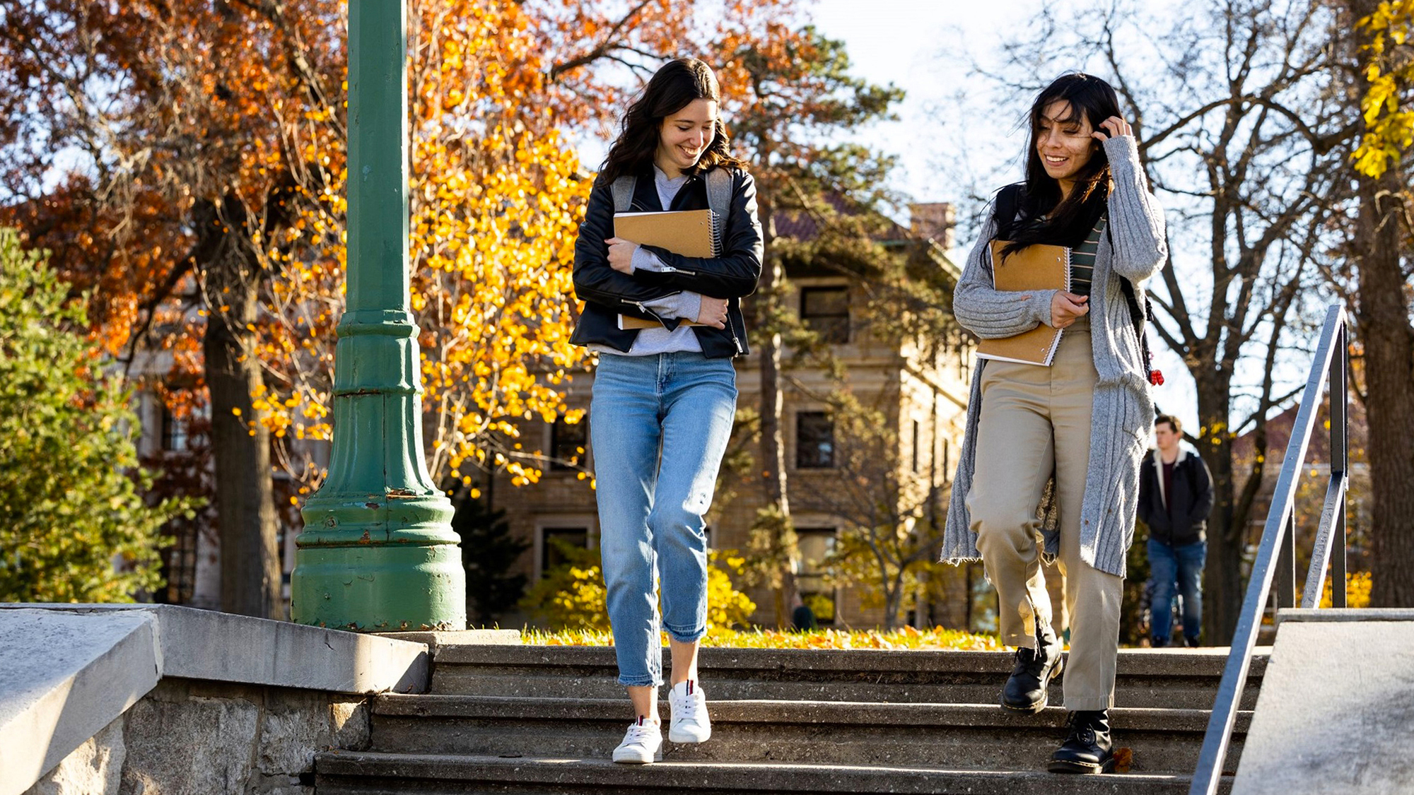 Female students walking with notebooks